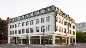 A historic hotel with a classic facade, large windows, and a prominent corner entrance.