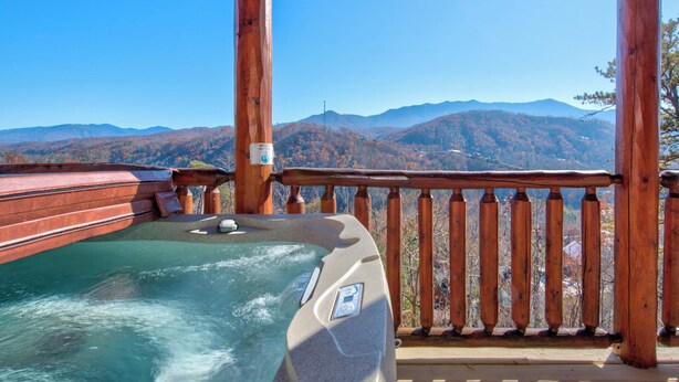 A hot tub on a wooden deck with a mountain view. - Bear's Eye View by Jackson Mountain Rentals (Gatlinburg)