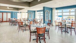 A spacious dining area with multiple tables and chairs, large windows with views, and a modern ceiling design. - NO OWNER FEES! Gorgeous Updated OCEANFRONT 2/2 Suite, OF Master, W/D, 18th Fl (North Myrtle Beach)