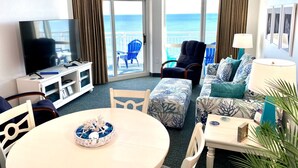 A hotel room with a balcony, a television, a dining table, and a sofa with a view of the ocean. - NO OWNER FEES! Gorgeous Updated OCEANFRONT 2/2 Suite, OF Master, W/D, 18th Fl (North Myrtle Beach)