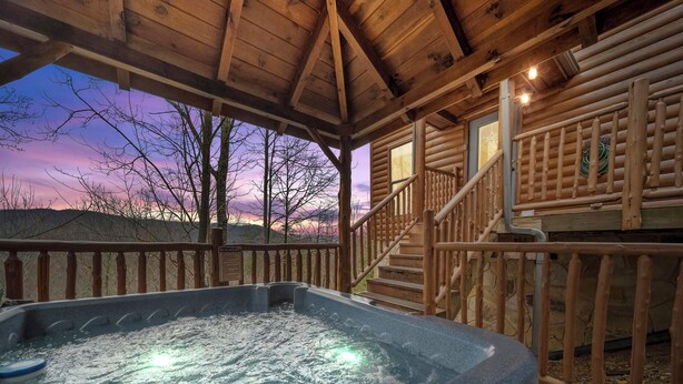 A hot tub in a wooden cabin with a view of the sunset. - Eden's View by Jackson Mountain Rentals (Gatlinburg)