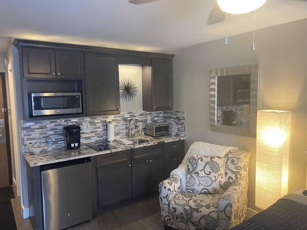 Enjoy a comfortable stay with a well-equipped kitchen featuring a microwave, dishwasher, and stylish backsplash.
