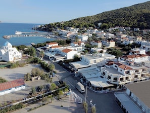 A coastal town with white buildings, a church, and a marina. - Agistri Hotel (Agistri)