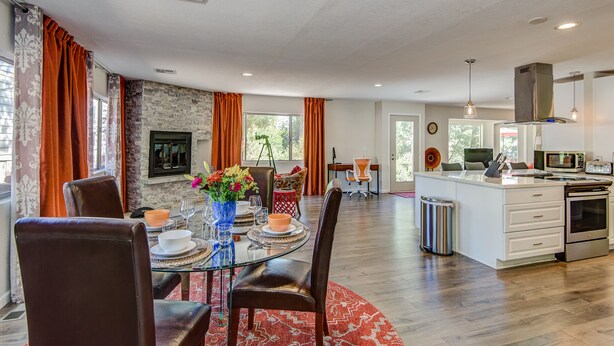 A spacious living area with a dining table, chairs, and a kitchen area with modern appliances. - Agave House, Views Of Chimney Rock, Pets OK! (Sedona)