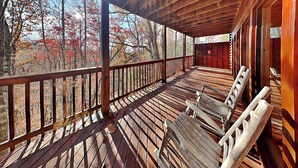 A wooden deck with a railing, a bench, and a ladder. - Hawks Point Lodge by Jackson Mountain Rentals (Sevierville)