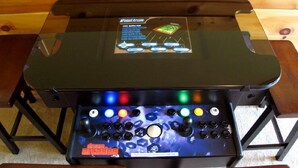 A gaming console with a transparent top and a control panel with multiple buttons and a joystick. - Highpoint Escape by Jackson Mountain Rentals (Gatlinburg)