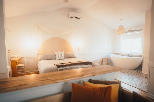 Comfy king sized bed next to an amazing 75’’ modern bathtub