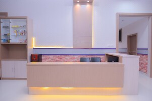 A modern kitchen with a central island, built-in cabinets, and a brick accent wall.