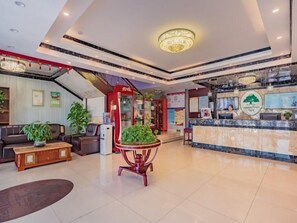 A hotel lobby with a reception desk, seating area, and a staircase. - Greentree Inn Beijing Yuegezhuang Hotel (Beijing)