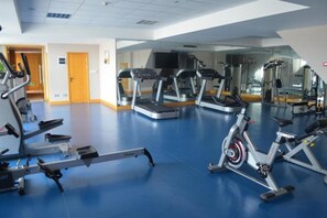 Ein Fitnessstudio mit Laufbändern, Ergometer und Rudergeräten.