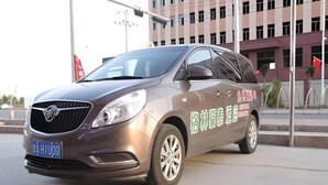 A car parked in front of a building with a sign that reads "Hotel". - Greentree Inn Lanzhou Zhongchuan Airport (Lanzhou)