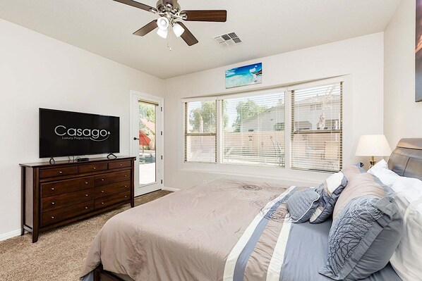 A bedroom with a bed, a TV, a ceiling fan, and a window with blinds. - Westgate Wonder ~ A Resort-Style Oasis w/ Heated Pool, Spa, Game Rooms, Putting Green & More! (Glendale)