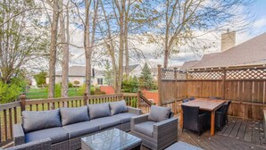 A deck with a sofa, chairs, and a table.