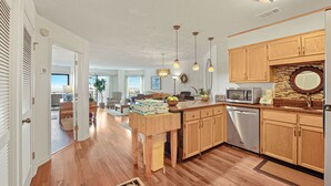 A kitchen with wooden cabinets, a dishwasher, and a microwave. - Beachfront Hilton Head Villa • Ocean Views & Pool Access (Hilton Head Island)