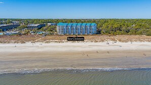 A coastal hotel with multiple buildings, a sandy beach, and ocean waves. - Oceanfront Villa | Direct Beach Access, Private Pool, King Suite & Ocean Views (Hilton Head Island)