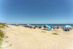 Miles of wide, sandy beach stretch along the shoreline, offering the perfect spot to relax, swim, or enjoy the ocean views.