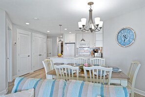 The dining area comfortably seats six and opens directly to the kitchen, creating a convenient space for family meals and gathering together.