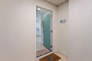 The open-air walkway keeps the space bright and breezy, while the unit's position limits foot traffic—creating a quieter arrival experience for guests.