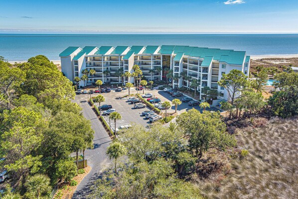 This elevated aerial view showcases a true oceanfront complex set directly along Hilton Head's wide, sandy shoreline.