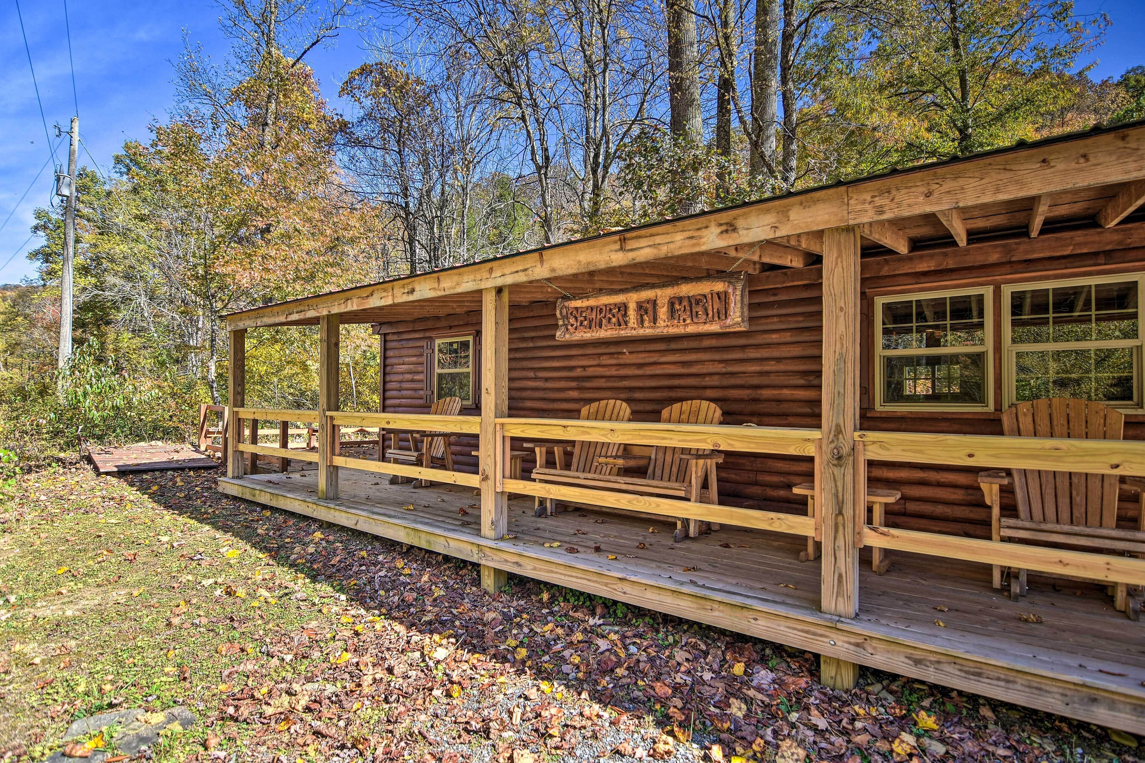 A rustic cabin with a wooden deck, multiple windows, and a sign reading "SEVERN FL CABIN".