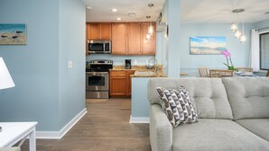 A modern kitchen with wooden cabinets, stainless steel appliances, and a central island.