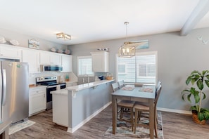 Enjoy meals in the kitchen with a central island and appliances, including an oven and microwave.