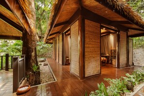 A wooden structure with a thatched roof, surrounded by lush greenery. - Lihim Resorts (El Nido)