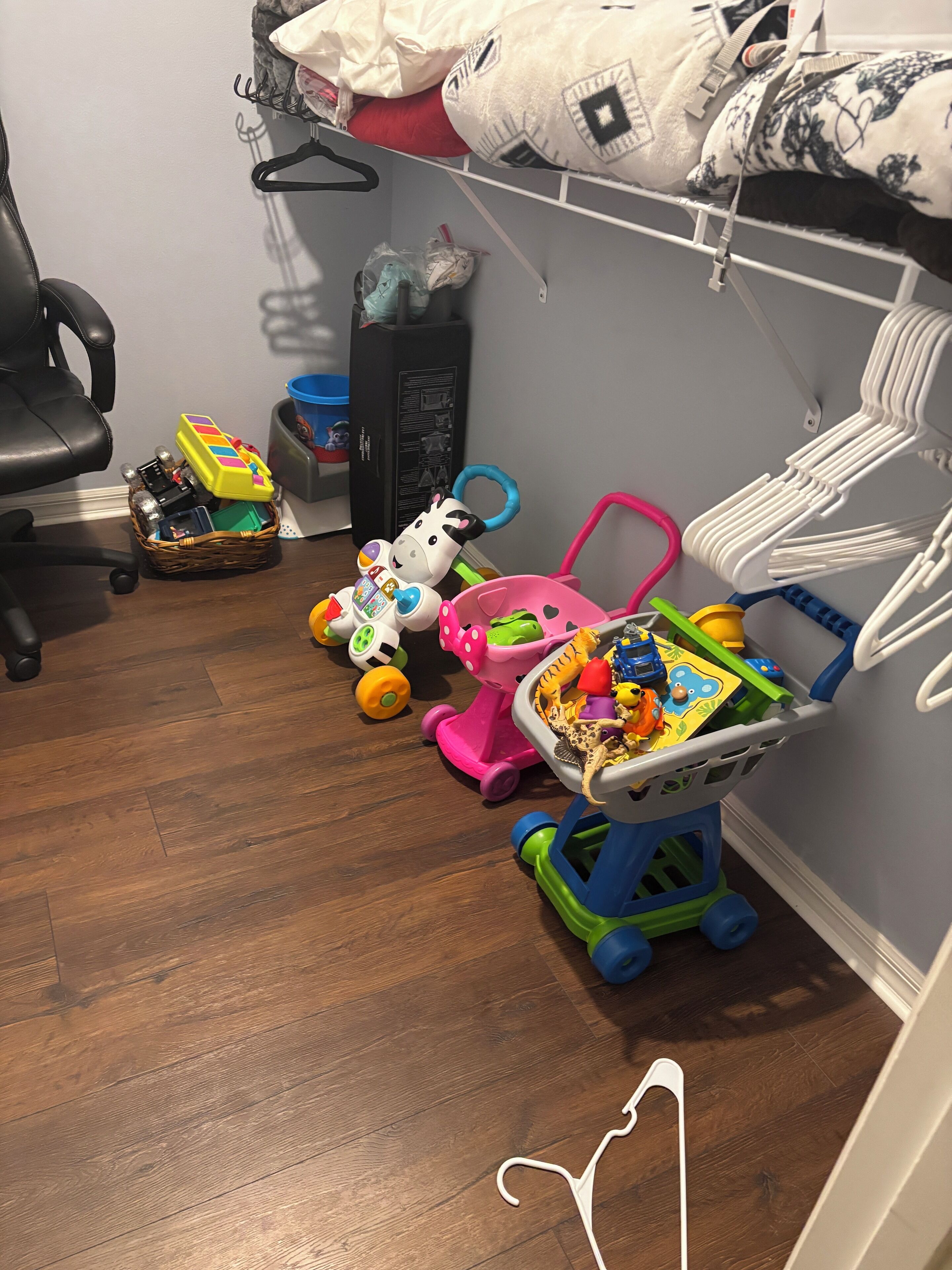 A child's play area with toys and a crib.