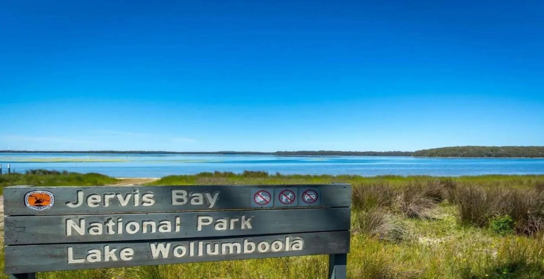 A sign for Jervis Bay National Park and Lake Wollumboola.