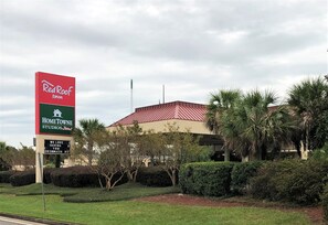 A Red Roof Inn sign with a HomeTown Studios sign below it. - HomeTowne Studios By Red Roof Augusta (Augusta)