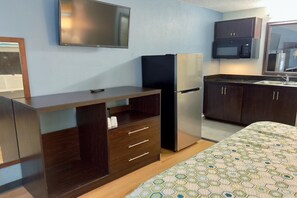 A compact kitchenette with a refrigerator, microwave, and sink. - HomeTowne Studios By Red Roof Augusta (Augusta)
