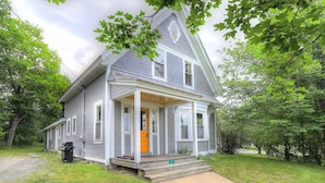 A two-story house with a porch, a small front yard, and a mailbox. - 🐾5 Pleasant Street - Conveniently located in town, dog friendly (Rangeley)
