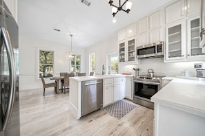 Enjoy cooking in this well-equipped kitchen with a central island, dishwasher, and stainless steel appliances.