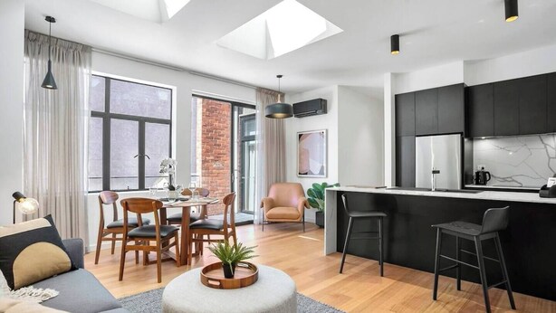 A modern apartment with a dining area, kitchen, and living space. - Sanctuary at Saddlers Where Rustic Meets Refined (Hobart)