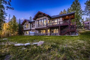 A large, multi-story house with a prominent balcony and a staircase leading to the upper level. - Horseshoe Lodge | VIP Shuttle | Hot Tub | Views! (Breckenridge)