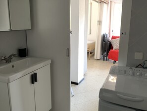 Bathroom features a sink, mirror, toilet, and bathtub.