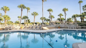 A pool area with lounge chairs and palm trees. - 403 Captains Walk - Palmetto Dunes 1st Floor Oceanfront - Hilton Head Rentals (Hilton Head Island)