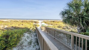 A wooden boardwalk leading to a beach with a clear view of the ocean and dunes. - 403 Captains Walk - Palmetto Dunes 1st Floor Oceanfront - Hilton Head Rentals (Hilton Head Island)