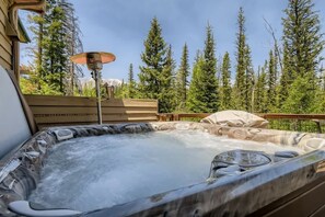 A hot tub with a wooden deck and a mountain backdrop. - 4BR Townhome w/ Private Hot Tub, Garage, and Deck (Silverthorne)