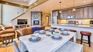 A modern kitchen with wooden beams, a dining area with a marble table, and a cozy living room with leather sofas. - Relax Fireside: Silverthorne Home 11 Mi to Skiing! (Silverthorne)