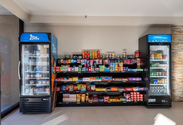 A vending machine area with a Blue Bunny ice cream dispenser and a beverage dispenser. - HomeTowne Studios by Red Roof Bordentown - McGuire AFB (Bordentown)