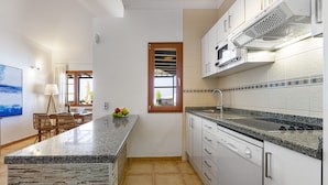 A modern kitchen with granite countertops, white cabinets, and a built-in dishwasher. - Villa 21, luxurious villa with heated pool (Puerto del Carmen)