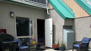 A residential building with a balcony, a garage, and outdoor seating. - Ski, golf, hike or bike right outside your door if you like! (Kimberley)