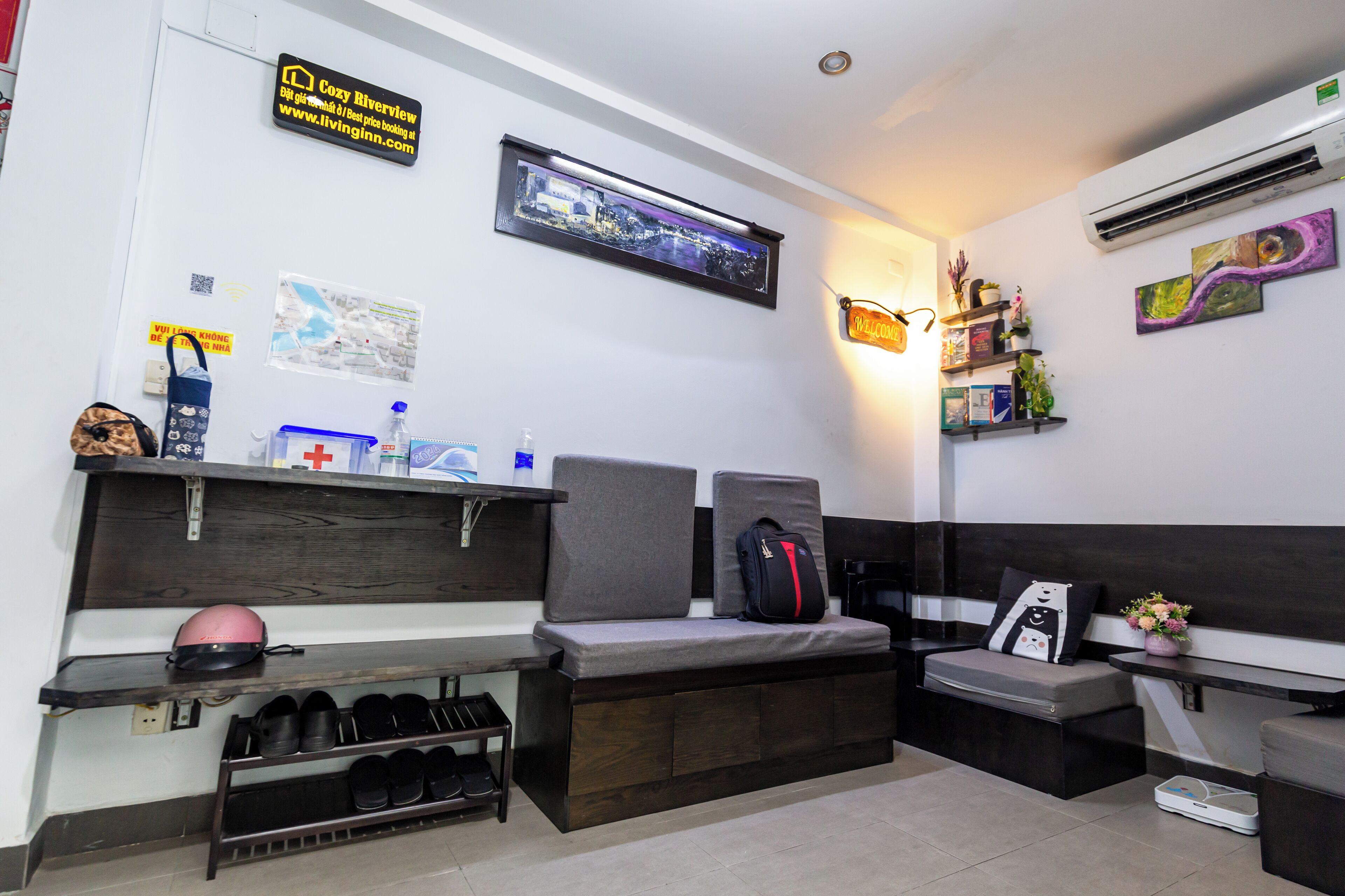 A modern waiting area with seating, a reception desk, and a wall-mounted air conditioner.