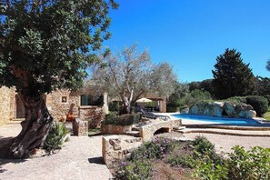 A stone courtyard with a swimming pool, stone architecture, and olive trees. - Finca BARRUBA, pool, Wi-Fi, air conditioning, 4 bedrooms, 4 bathrooms, garden, view, barbecue (Pollença)