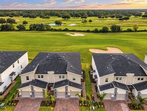 A residential area with modern houses and a golf course in the background. - Family Disney Retreat / Entertainment Room / Console Provided (Kissimmee)