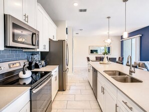 A modern kitchen with stainless steel appliances, a microwave, and a built-in oven.