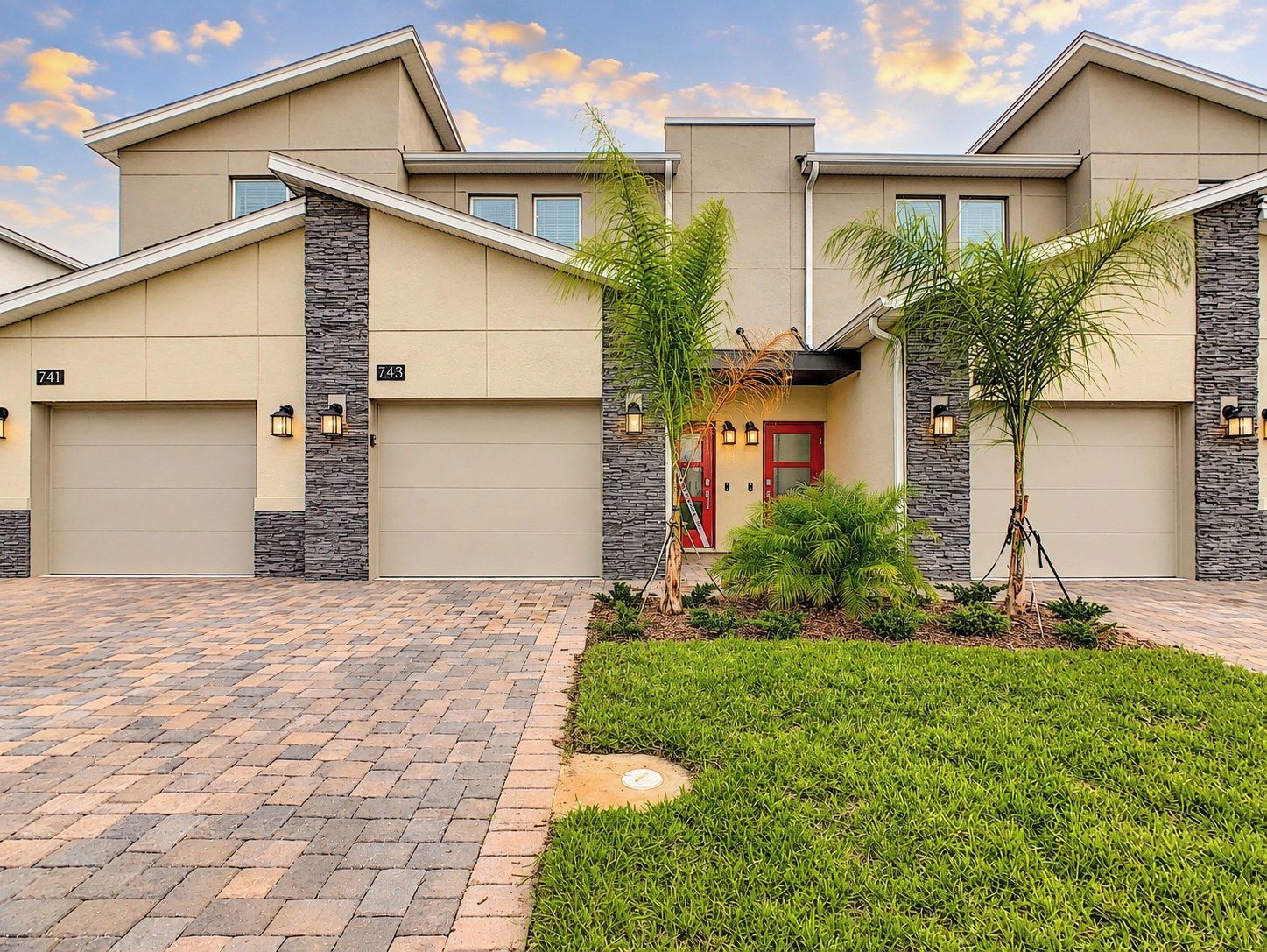 Modern Exterior with Paved Driveway and Palm Trees