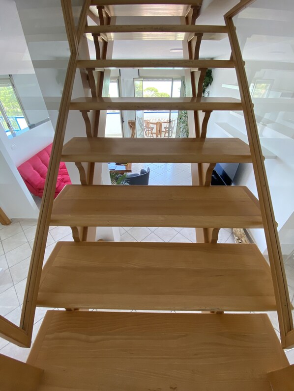 A wooden spiral staircase in a modern interior. - --Sunrise-- (Montesilvano)