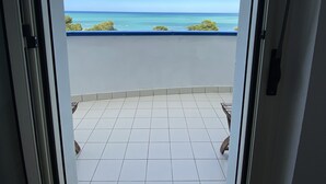 A view from a balcony with a tiled floor and a clear blue sky. - --SunRise-- (Montesilvano)